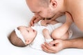Little innocent baby girl smiles sweetly and tenderly looking into Dad`s eyes