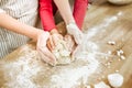 Little interested child gently hugging piece of unready dough Royalty Free Stock Photo