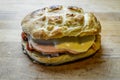 Little italian focaccia bread stuffed with turkey ham, red bell peppers, cheese and red onions on wooden cutting board Royalty Free Stock Photo