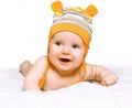 Little joyful baby in cap crawling