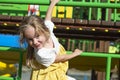 Little joyful girl playing on the playground