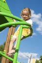 Little joyful girl playing on the playground