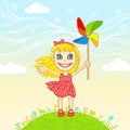 Little joyful girl plays a pinwheel