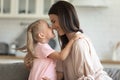 Little joyful kid girl touching noses with happy young mommy. Royalty Free Stock Photo