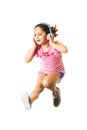 Little jumping caucasian girl with a headphones