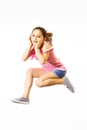 Little jumping caucasian girl on white background