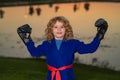 Little karate fighter. Kid boy practicing karate outdoor. Sport karate kids fighter. Little boy wearing kimono doing Royalty Free Stock Photo