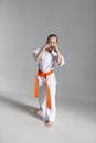 A little karate girl in a white kimono in a fighting stance Royalty Free Stock Photo