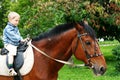 Little kid on big horse Royalty Free Stock Photo