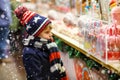 Little kid boy with candy cane stand on Christmas Royalty Free Stock Photo