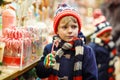 Little kid boy with candy cane stand on Christmas Royalty Free Stock Photo