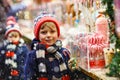 Little kid boy with candy cane stand on Christmas Royalty Free Stock Photo