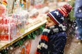 Little kid boy with candy cane stand on Christmas market Royalty Free Stock Photo