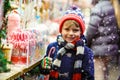 Little kid boy with candy cane stand on Christmas market Royalty Free Stock Photo