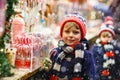 Little kid boy with candy cane stand on Christmas market Royalty Free Stock Photo