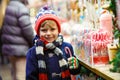 Little kid boy with candy cane stand on Christmas market Royalty Free Stock Photo