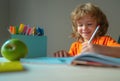 Little kid boy is doing his homework for elementary school. Royalty Free Stock Photo