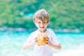 Little kid boy drinking coconut juice on tropical beach Royalty Free Stock Photo