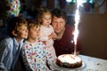 Little kid boy and family, father, brother and baby sister celebrating birthday