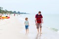 Little kid boy and father having fun with collecting shells Royalty Free Stock Photo