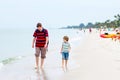 Little kid boy and father having fun with collecting shells Royalty Free Stock Photo