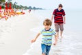 Little kid boy and father having fun with collecting shells Royalty Free Stock Photo