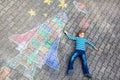 Little kid boy flying by a space shuttle chalks picture Royalty Free Stock Photo