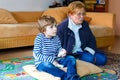 Little kid boy and grandmother playing video game console Royalty Free Stock Photo