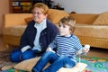 Little kid boy and grandmother playing video game console Royalty Free Stock Photo