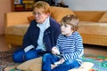 Little kid boy and grandmother playing video game Royalty Free Stock Photo