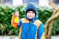 Little kid boy hanging bird house on tree for feeding in winter Royalty Free Stock Photo