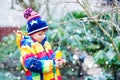 Little kid boy hanging bird house on tree for feeding in winter Royalty Free Stock Photo