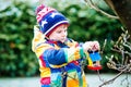 Little kid boy hanging bird house on tree for feeding in winter Royalty Free Stock Photo