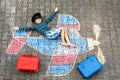 Little kid boy having fun with with airplane picture drawing with colorful chalks on asphalt. Child painting with chalk