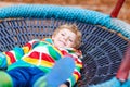 Little kid boy having fun on autumn playground