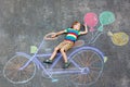 Little kid boy having fun with bicycle chalks picture on ground Royalty Free Stock Photo