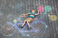 Little kid boy having fun with bicycle chalks picture on ground Royalty Free Stock Photo