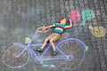 Little kid boy having fun with bicycle chalks picture on ground Royalty Free Stock Photo