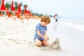 Little kid boy having fun with building sand castles Royalty Free Stock Photo