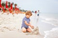 Little kid boy having fun with building sand castles Royalty Free Stock Photo