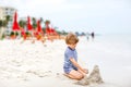 Little kid boy having fun with building sand castles Royalty Free Stock Photo
