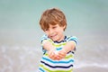 Little kid boy having fun with collecting shells Royalty Free Stock Photo