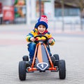 Little kid boy having fun on toy race car outdoors Royalty Free Stock Photo