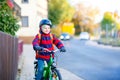 Little kid boy in helmet riding with his bicycle in the city Royalty Free Stock Photo