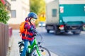 Little kid boy in helmet riding with his bicycle in the city Royalty Free Stock Photo