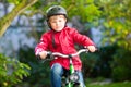 Little kid boy in helmet riding with his bicycle in the city Royalty Free Stock Photo