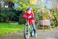 Little kid boy in helmet riding with his bicycle in the city Royalty Free Stock Photo
