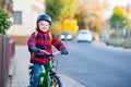 Little kid boy in helmet riding with his bicycle in the city Royalty Free Stock Photo