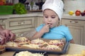 Little kid boy helps mother to cook pizza. Happy family mom and child Royalty Free Stock Photo