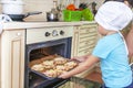 Little kid boy helps mother to cook pizza. Happy family mom and child in weekend morning at home. Relationship Royalty Free Stock Photo